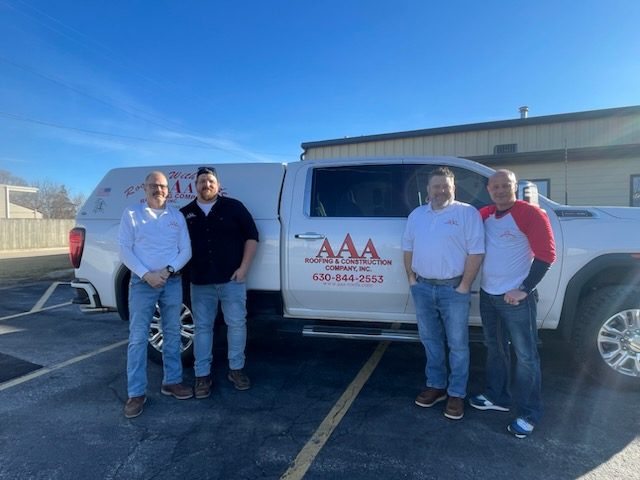 The AAA Roofing Company team in front of their truck